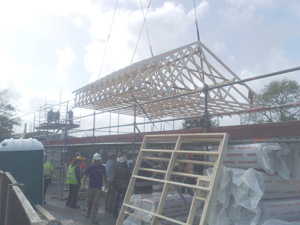 roof truss being lifted into place